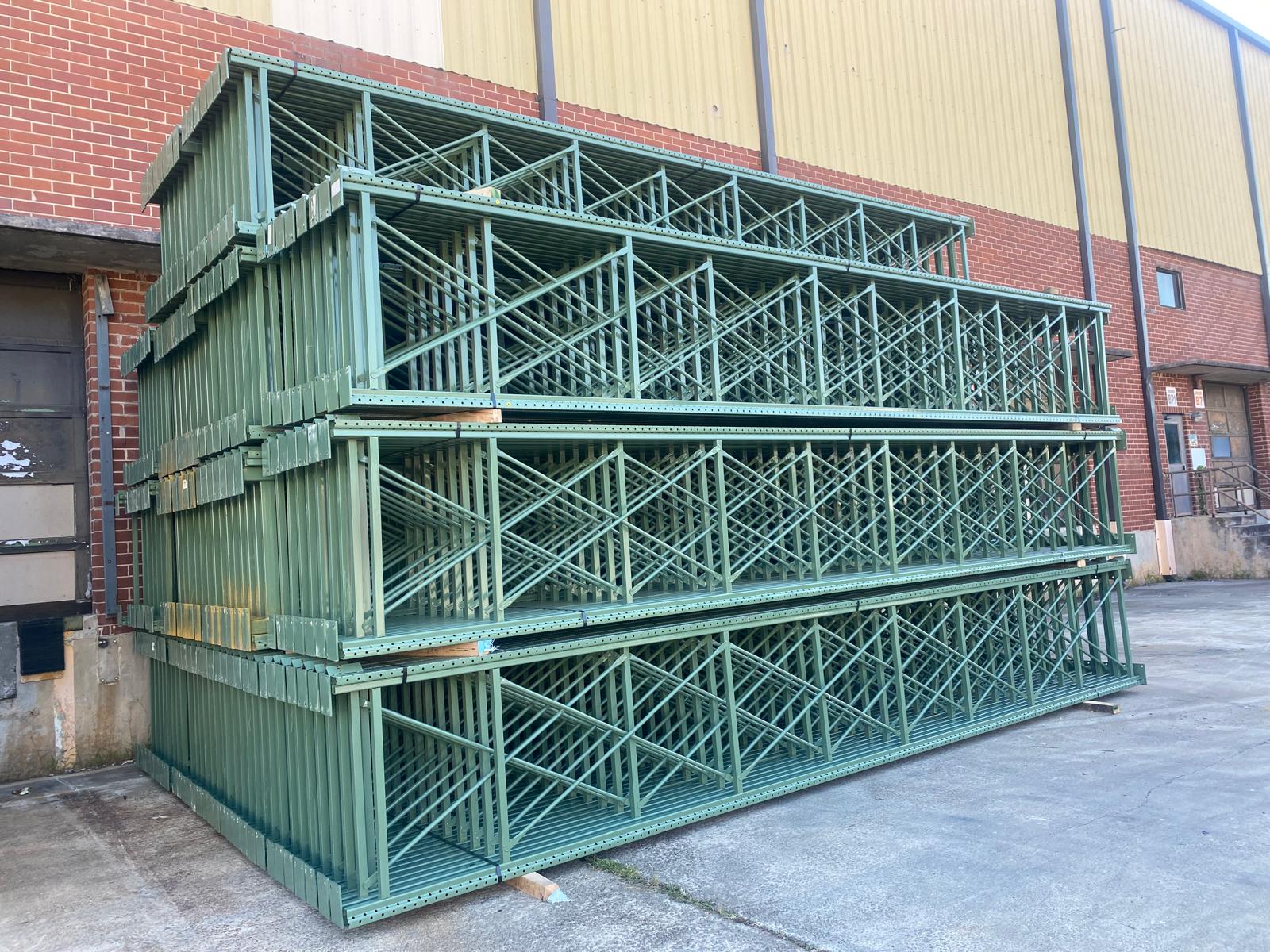 Technician evaluating used pallet racking during a buyback assessment