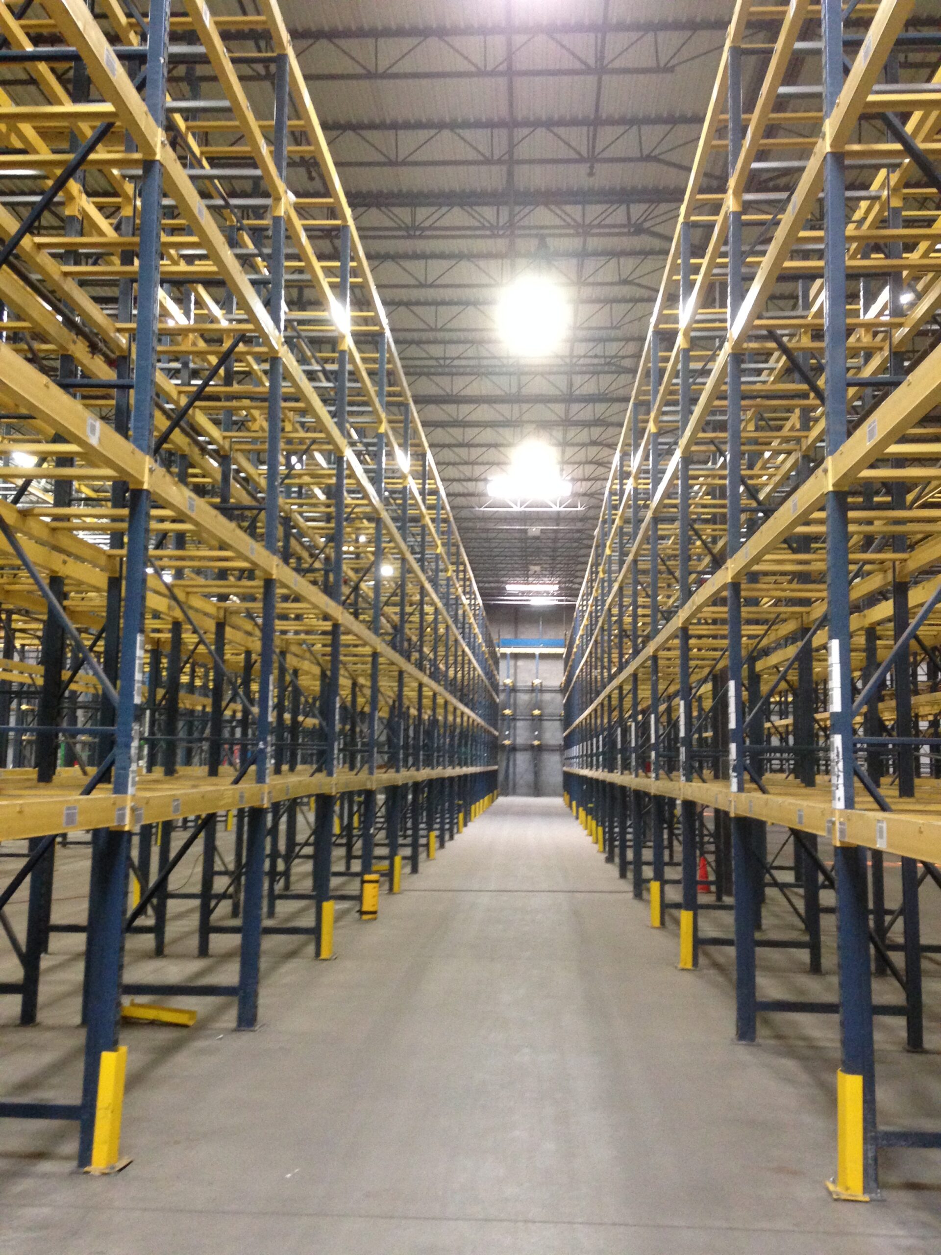 Installation crew assembling pallet racking on-site in a warehouse